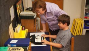 A student learning braille in class