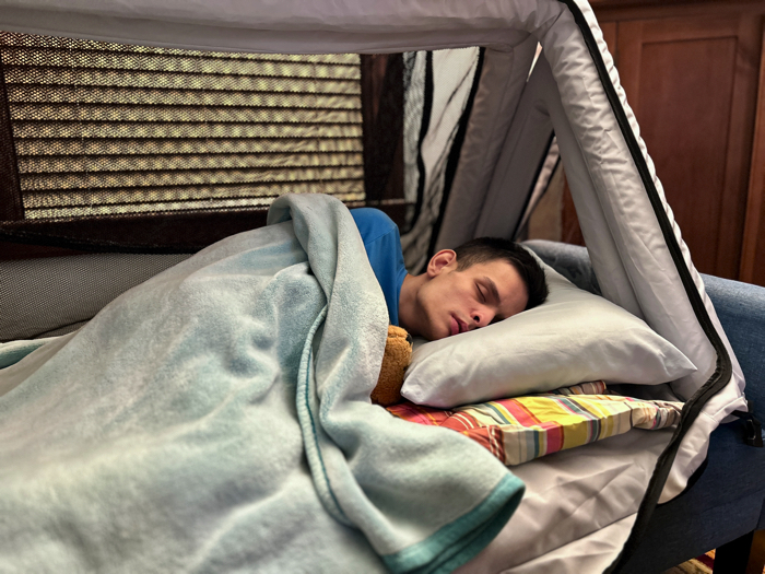 Ivan sleeping comfortably in his new Safe Place Bedding Travel Bed.