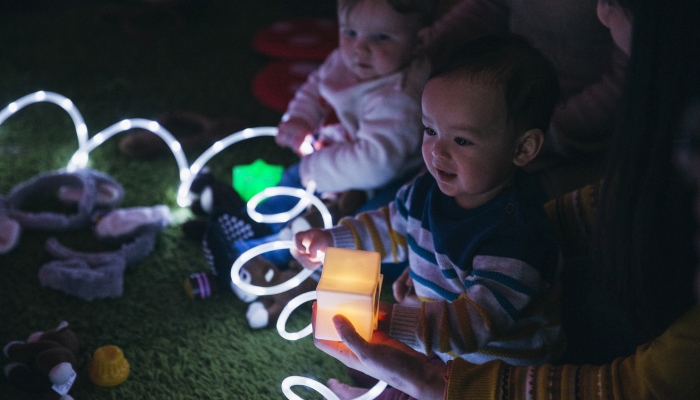 https://www.wonderbaby.org/wp-content/uploads/2022/08/Close-up-shot-of-a-baby-boy-having-fun-in-a-sensory-group-with-illuminated-toys.jpg