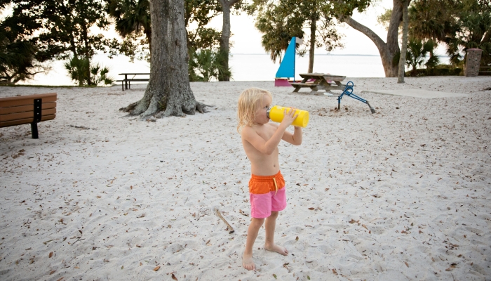 Boy Drinking With Yellow Bottle