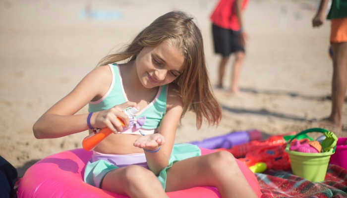Young Girl Putting Sunscreen Lotion