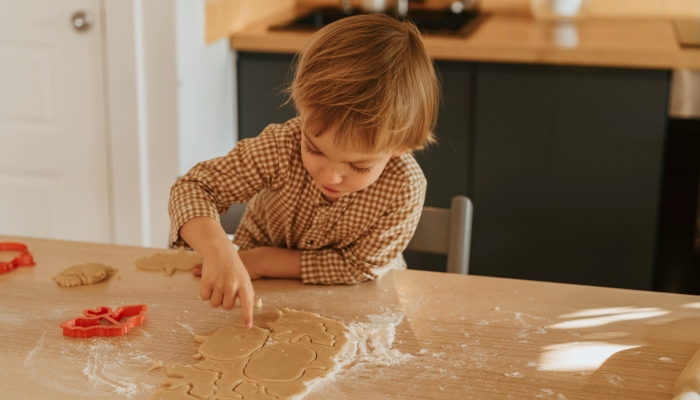 A Kid Separating Shaped Dough