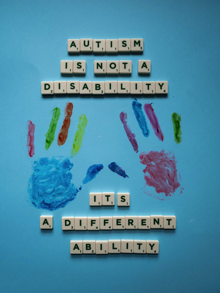 Scrabble tiles spelling out "autism is not a disability, it is a different ability."