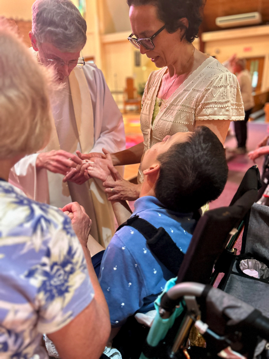 Ivan at a healing service being anointed with oil.