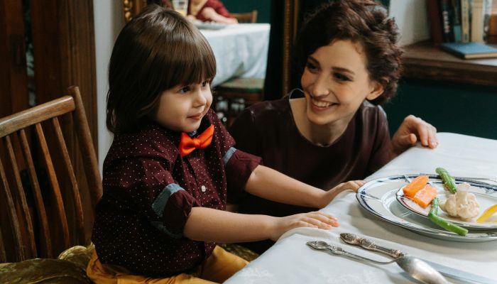 A Mother and Child Having a Formal Dinner