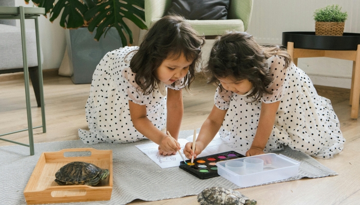 Little Twin Girls Painting and Their Pet Turtles Walking Around Freely