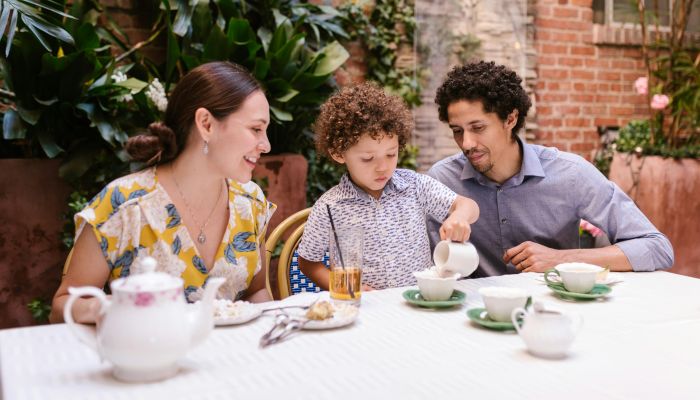 Parents with a Little Son Sitting at the Table in a Restaurant