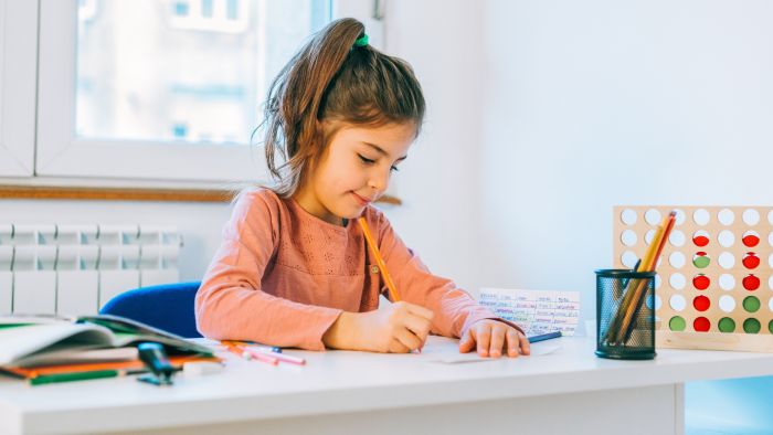 Girl sitting at a desk doing art to self regulate intense emotions