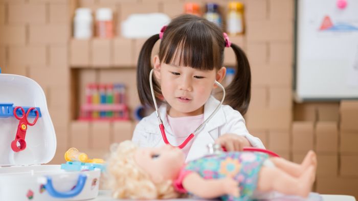 Girl role-playing as a doctor to practice self regulation skills