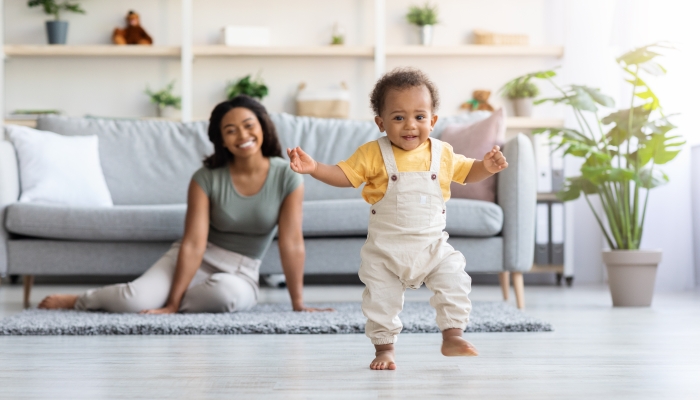 Adorable Black Infant Child Walking In Living Room At Home