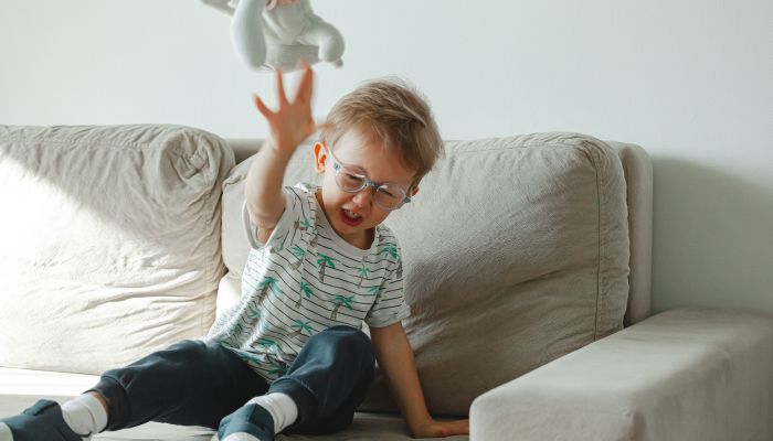 Angry child throwing stuff animal