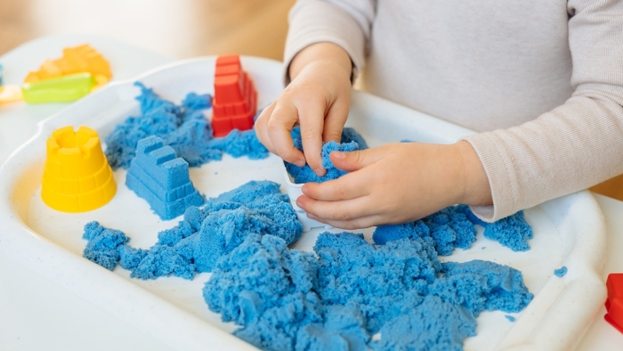 Child playing with coloured sand