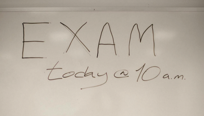 Words "exam today" written on a white board