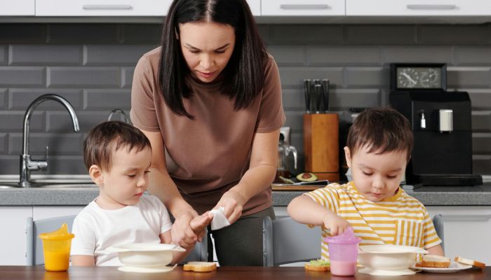 Mother and Kids at Breakfast in Kitchen