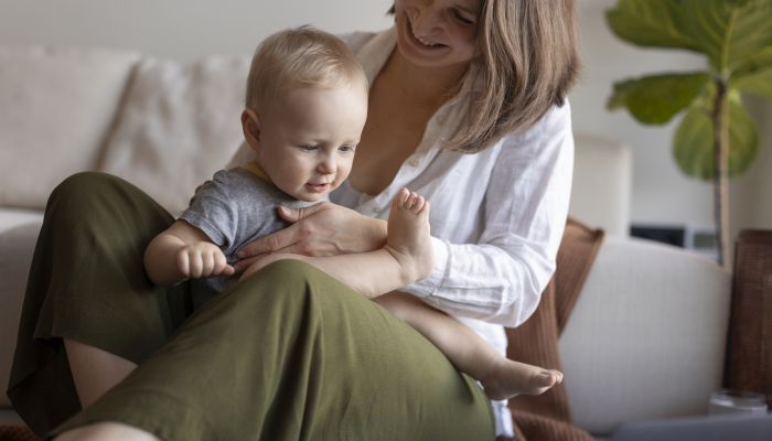 Mother breast feeding her child while working