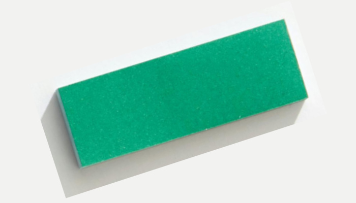 Green paper rectangle on a white background.