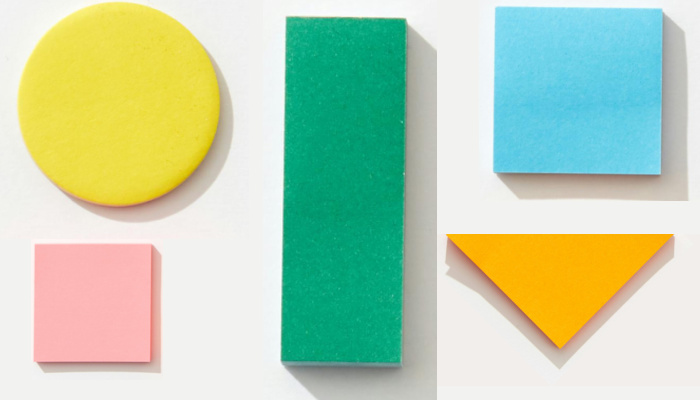 Colorful paper shapes on a white background.