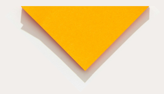 Orange paper triangle on a white background.