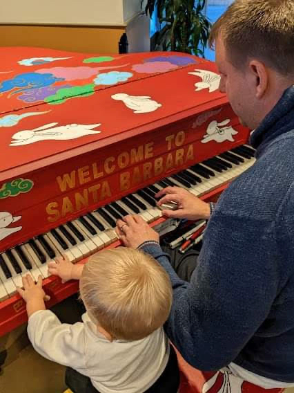 Peter playing piano with his father.